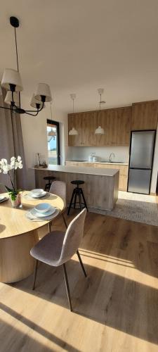 a kitchen with a table and chairs and a counter at Eko Osada Zacisze in Ostrowite
