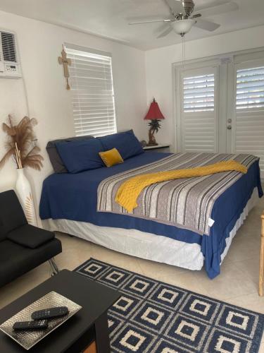 a bedroom with a bed with blue and yellow sheets at Stunning suite by hard rock stadium and casino in Miami