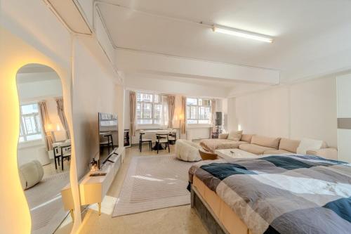 a large white room with a bed and a living room at Huge Studio and Rooftop in Central in Hong Kong