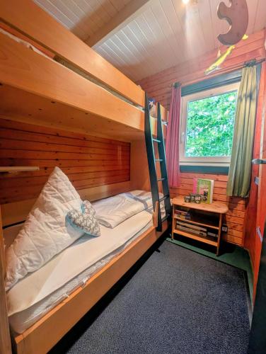 a bedroom with a bunk bed in a cabin at Kysthus in Damp