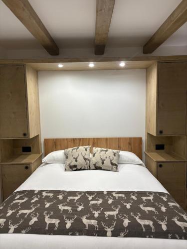 a bedroom with a bed with a black and white blanket at B&B Dimora della Fonte in Roccaraso
