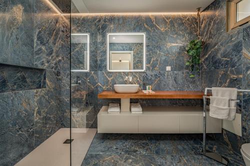 a bathroom with a sink and a mirror at The Viewpoint by Eurostay in Ribeira Brava
