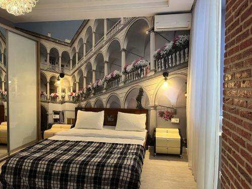 a bedroom with a bed and a wall with flowers at Апартаменти Площа Ринок in Lviv