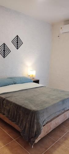a bedroom with a large bed with three crosses on the wall at Terrazas al Sol 03 in Playa Hermosa