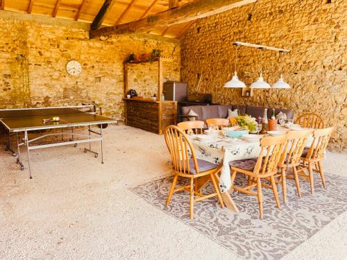 a dining room with a ping pong table and chairs at Le Reve de Breuillac in Surin