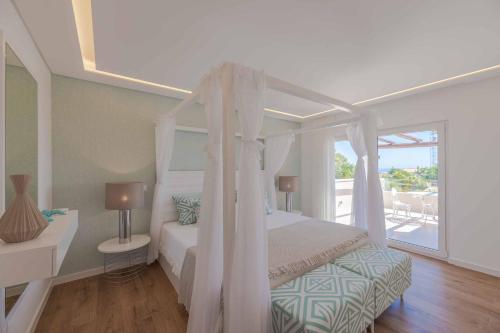 En eller flere senge i et værelse på Casa da Praia