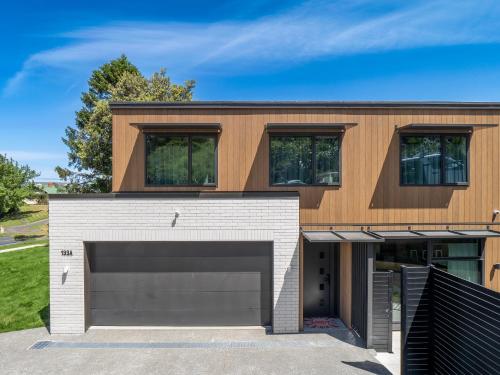a house with a garage at Architectural Retreat in Prestigious Whanganui in Whanganui