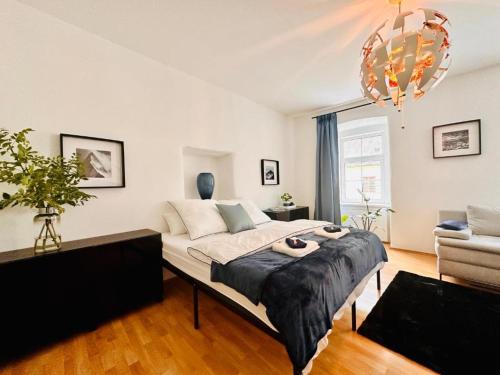 a bedroom with a bed and a living room at White Oak Loft in Schottwien
