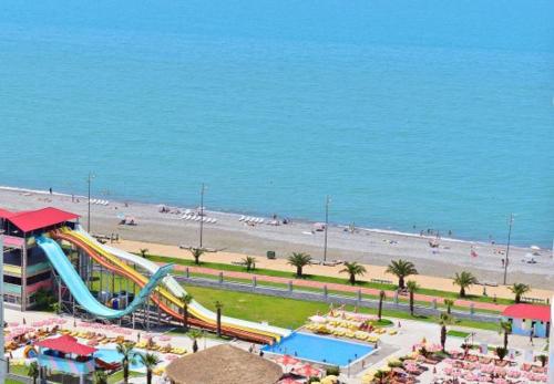 an amusement park with a slide and a beach at Batumi Inn Hotel in Batumi