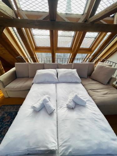 a large bed with two pairs of socks on it at Schwarzwald Mauer Loft in Bräunlingen