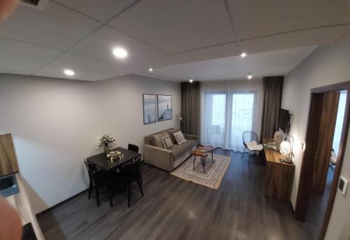 a living room with a couch and a table at Apart Hill in Sosnówka