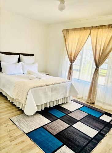 a bedroom with a bed and a large window at Small town comfort in Marquard