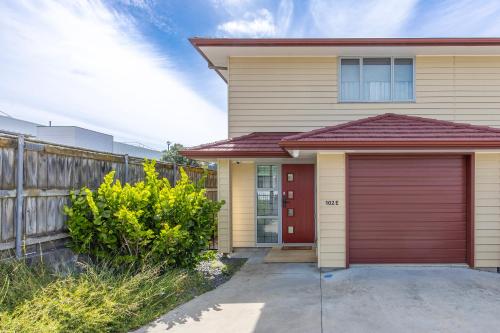 a house with a red garage at Stylish apartment Whanganui in Whanganui