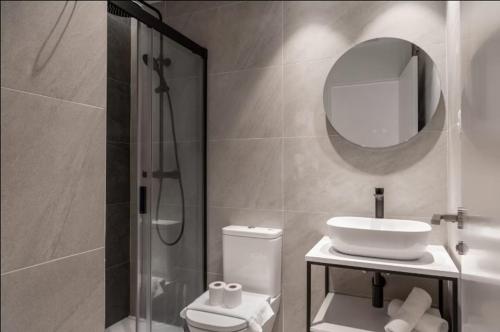 a bathroom with a toilet and a sink and a shower at Genesis-Loft San Enrique 14 in Madrid