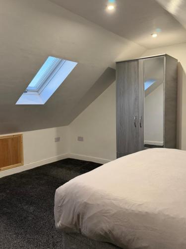 a bedroom with a bed and a skylight at Nightingale Roomz in Lower Darwen
