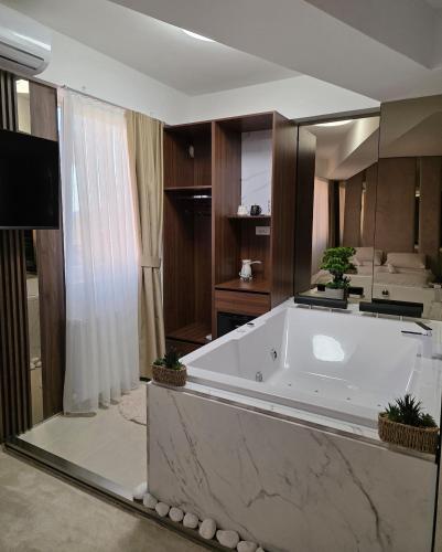 a large bathroom with a large tub with potted plants at PETKOV5KI LuxuryApartment in Skopje