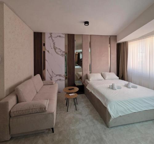 a hotel room with a bed and a couch at PETKOV5KI LuxuryApartment in Skopje
