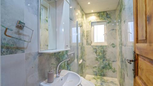 a bathroom with a sink and a shower at Villa Neymar in Kaş