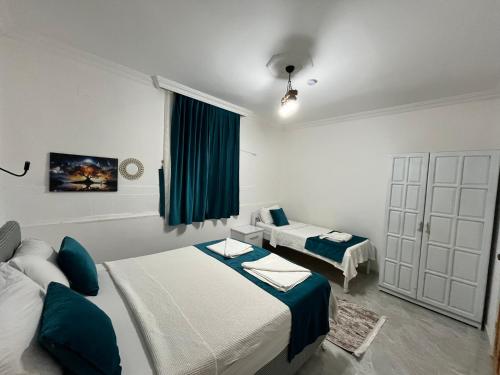 a hotel room with two beds and a window at Villa Neymar in Kaş