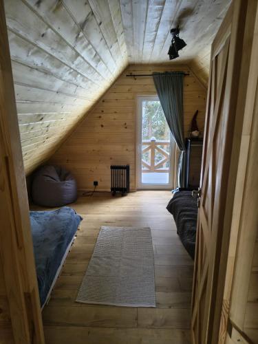 a room with a attic with a bed and a window at Juraszówka in Kamesznica