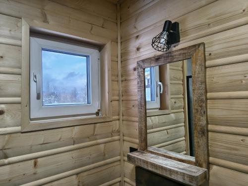 a bathroom with a mirror and a window at Juraszówka in Kamesznica