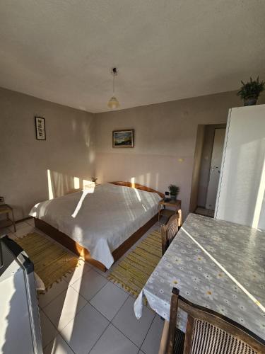 a bedroom with a bed and a table in it at Villa Lira in Pavel Banya