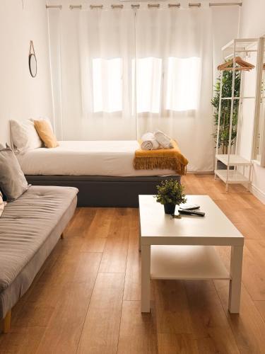a living room with a bed and a table at Genesis-Loft San Enrique 20 in Madrid