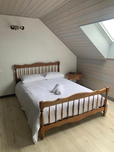 a bedroom with a large bed in a attic at Val et Mer House in Ault