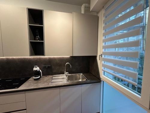 a kitchen with a sink and a window at Colombo Central Apartment in Garda