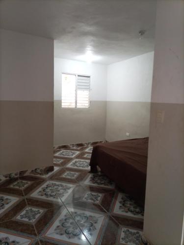 a bedroom with a bed and a tiled floor at Cabeza De Toro, Locales in Punta Cana