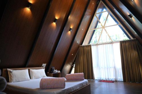 En eller flere senge i et værelse på Coffee Gudda Resort