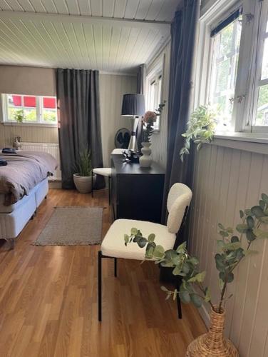 a bedroom with a bed and a desk with a chair at Kungsskogen Kolmården in Kolmården