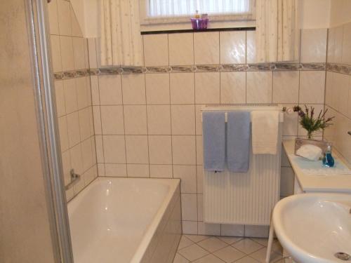 a bathroom with a tub and a sink at Haus Mittelberg in Olsberg