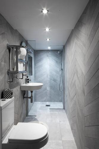 a bathroom with a shower and a toilet and a sink at Stylish-Luxury Seaside Flat on Georgian Square in Hastings