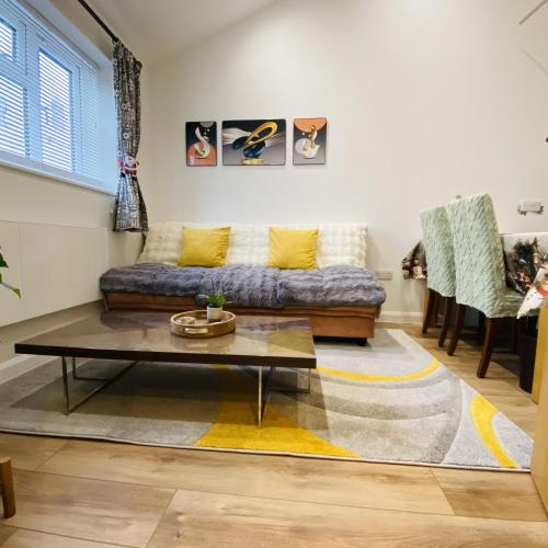 a living room with a couch and a coffee table at Modern, Brand-new Detached House in Oxford