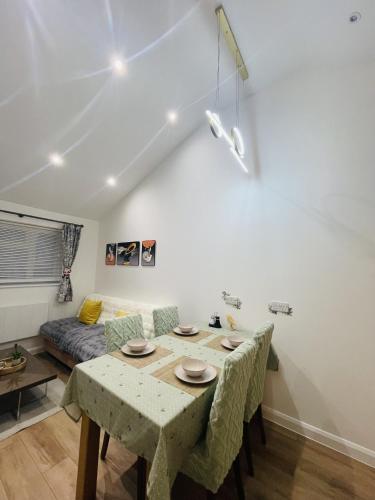 a living room with a table and a couch at Modern, Brand-new Detached House in Oxford