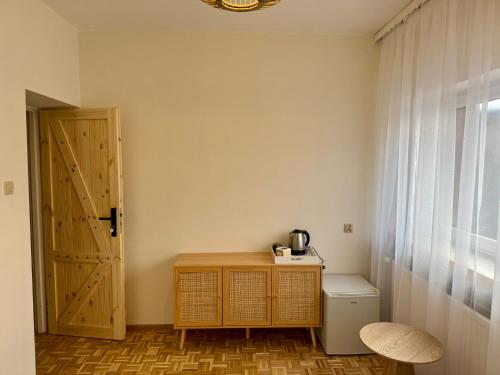 a room with a door and a table and a toilet at Uroczysko pod Babią Górą in Zawoja
