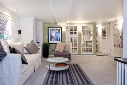 a living room with a couch and a table at Downtown Large Apt with parking Convention Center in Washington, D.C.