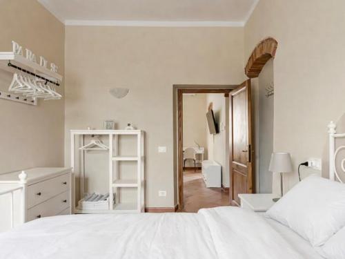 a white bedroom with a white bed and a mirror at Paradise Apartment, Comfort e Private Parking in Prato