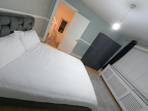 a bedroom with a large white bed and a window at Cozy home in Birmingham