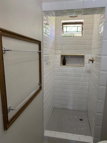 a shower with a glass door in a bathroom at The cozy acre in Potchefstroom