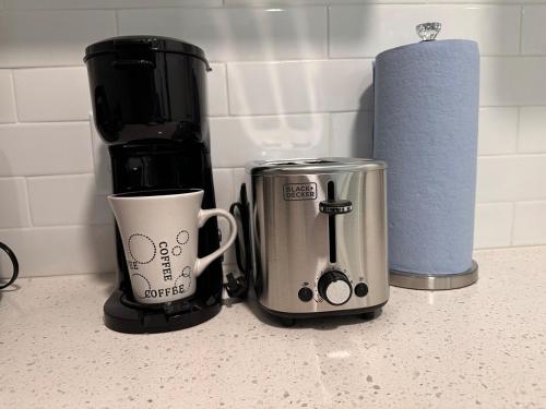 a coffee maker and a coffee mug on a counter at My Dream Space in Orange Park