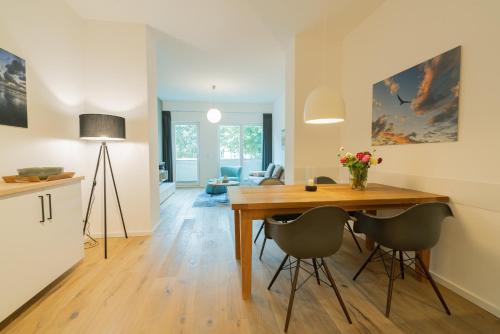 a kitchen and dining room with a table and chairs at Wave1 in Norderney