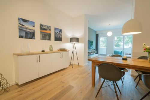 a kitchen with a desk and a dining room at Wave1 in Norderney