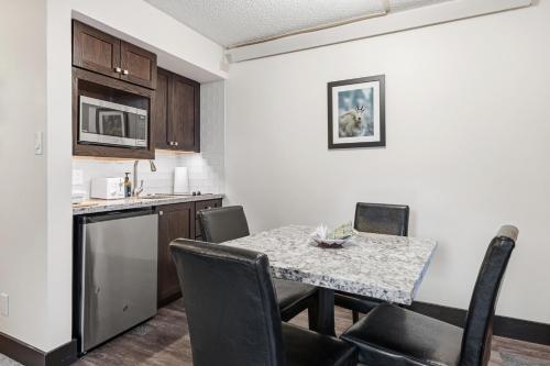 a kitchen and dining room with a table and chairs at Lift House Lodge, Close to Gondola, Premium Studio Condo in Vail