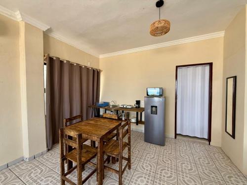 a dining room with a table and a refrigerator at Puerto 201 ROOMS in Veracruz
