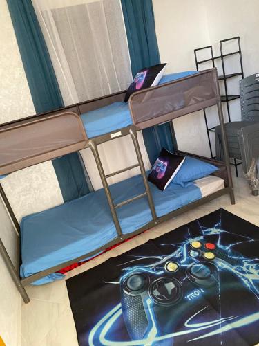 a bunk bed in a room with a rug at Mini villa trougout in Al Hoceïma