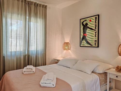a bedroom with a bed with two towels on it at Villa Porto in Rogač