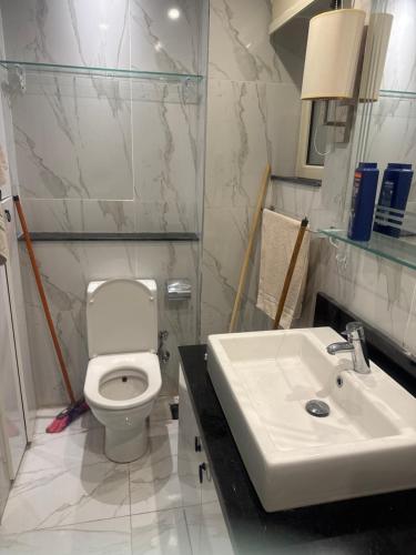 a bathroom with a white toilet and a sink at Veranda resort in Hurghada