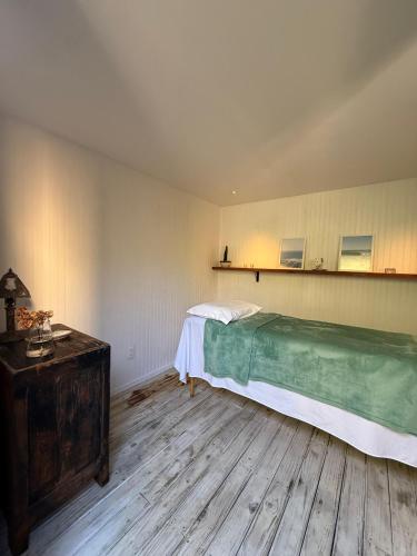 a bedroom with a bed and a wooden floor at Casa Flor in Punta del Este